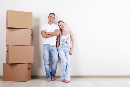 Removal team safely handling boxes and furniture during a move