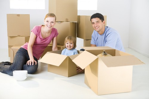 Moving team handling packed household boxes during a removals service
