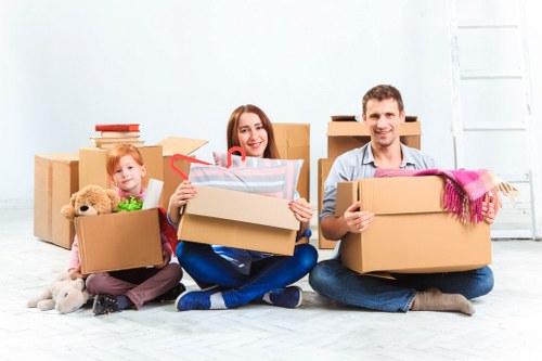 Staff wearing PPE while moving belongings in a residential property