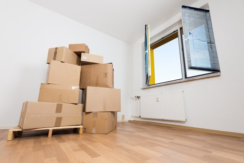 Packed boxes and furniture prepared for a South Kensington removal van