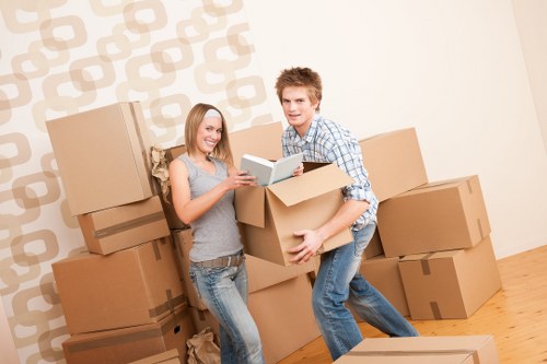 Removal team transporting boxes and furniture in a Southkensington home move