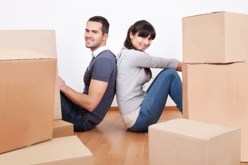 A local removals team handling office furniture in a South Kensington street