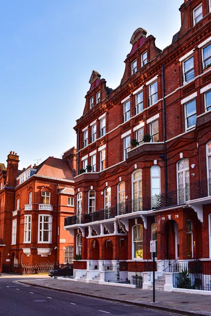 Image of a multi-story Victorian-style residential building on a busy urban street in South Kensington, with detailed decorative brickwork and large sash windows. The building's facade features light-